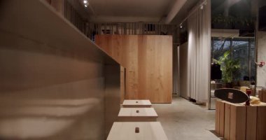 Ahşap mobilyaları ve metal tezgahı olan modern bir mağaza. Kaykay meraklıları için şık bir yer. Sıcak ışıklandırma sıcak ve davetkar bir atmosfer yaratır. Perakende ve alışveriş için mükemmel.
