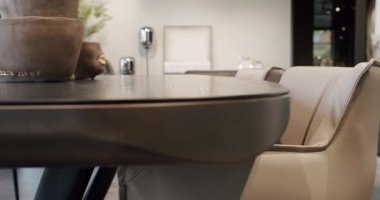 Kitchen Dining Room with wooden table and modern leater chairs. Beautiful kitchen interior with new stylish furniture. Modern Apartment. Dining Area And Lounge In Stylish And Contemporary Empty Home.