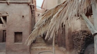 Geleneksel bir Fas köyü sahnesi. Kırsal binalar, dokulu duvarlar ve sazdan çatı yapısı. Bu, tarih, kültür ve ebedi güzelliği çağrıştırıyor..