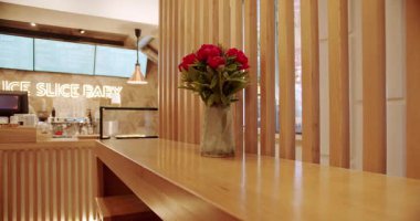 Ahşap sandalyesi ve masası olan modern minimalist bir kafe. Modern ahşap sandalye ve masa. Boş yemek kumaşı ve tahta sandalye. Kafede modern ekipmanlar var. Müşteri kabul etmek için tahta tezgah.