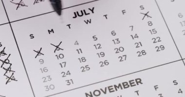 Siyah kalemle karalanmış günlerin olduğu Temmuz takvim sayfası. Zaman, son teslim tarihi ve önemli tarih kavramı. Takvimdeki Günlerin Üstünden Geçiliyor