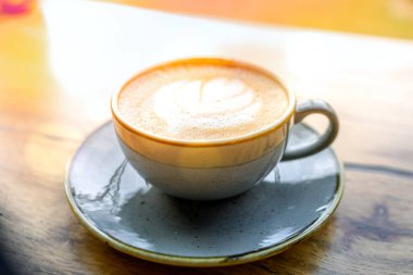 Coffee drink on wooden table with blur background