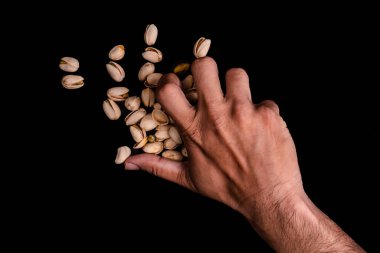 Pistachios Yığını ve az miktarda fıstık toplayan, Kara Arka plan 'da izole edilmiş