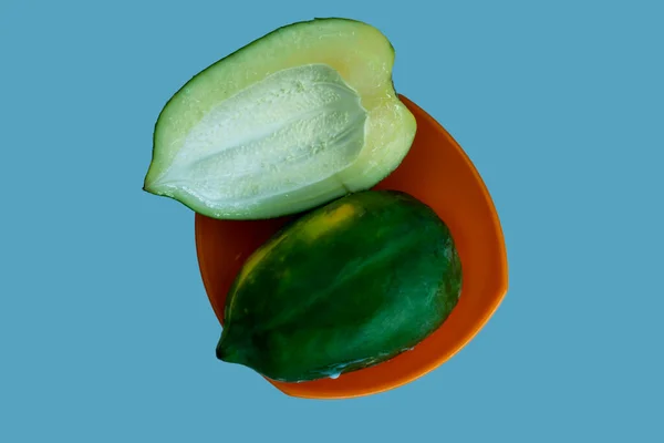 Two Peace Green Papaya Orange Bowl Isolated Cyan Background — Stock Photo, Image