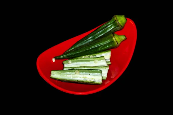 stock image green hot peppers on black background