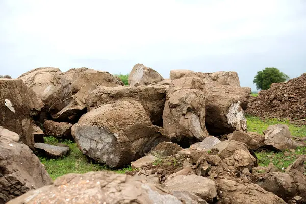 Stock image This stock image beautifully encapsulates the essence of raw nature, featuring a cluster of weathered boulders set against a gloomy sky. It conveys powerful themes of endurance and the wild, untamed wilderness.