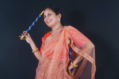 Grace in Motion: Emerging Indian Ladies Prepared to Act Out Dandiya in Customary Clothes clipart