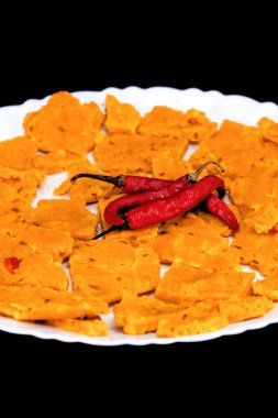 Gujarati Kathiyawadi Spicy Dhokali Sabji in a portrait format, elegantly placed on a white plate, with a dramatic black backdrop that accentuates its features clipart