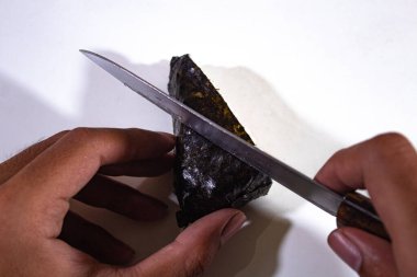 Onigiri 'nin yarısı bir bıçak ve iki elle kesilecek.