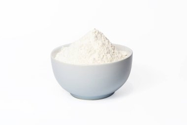 white ceramic bowl of flour isolated on white background