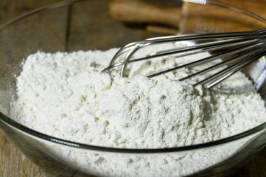 Preparing white all-purpose flour in the glass bowl homemade bakery. bakery background