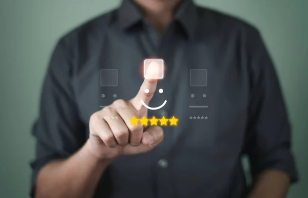 stock image Customer service and Satisfaction concept, Businessmen touch the virtual screen on the happy Smiling face icon to give satisfaction in service. rating very impressed