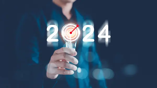 Business target and goals trends 2024, Analytical Businessman holding light bulb with planning business growth 2024, New business start up, technical analysis strategy, strategy digital marketing.