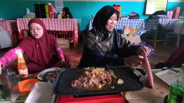 Asian Hijab Wearing Women Grilling Meat Indoor Event Video Footage — Video