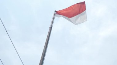 Endonezya Bayrağı açık havada dalgalanırken arkamızda mavi gökyüzü bayrak direğinde Endonezya bayrağı. Rüzgarda dalgalanan Endonezya bayrağı. Endonezya Ulusal Bayrağı