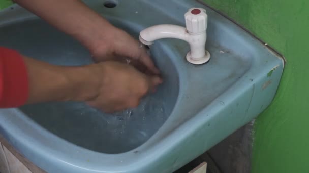 Asian Man Red Shirt Attempting Turn Tap Water Flows Out — Stock Video
