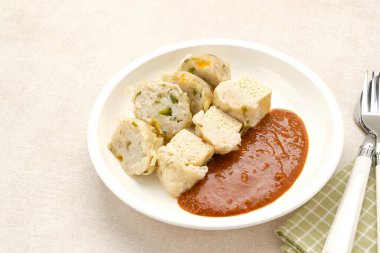 Siomay Bandung (Shumay) or steamed dumplings with boiled tofu. Indonesian traditional street food with peanut sauce. clipart