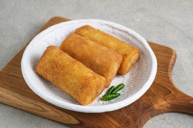 Risoles Rogout, Indonesian traditional savory snack. Filled with chicken chopped and mix vegetable, covered with bread crumb and deep fried. Served in white plate with chilli. clipart