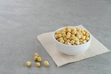 Kacang Arap ya da gri arka planda beyaz kasede nohut. Metin için boşluk.