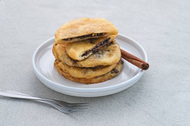 Hotteok, South Korean pancakes or fried dough with nuts and sugar filling, traditional street food.  clipart