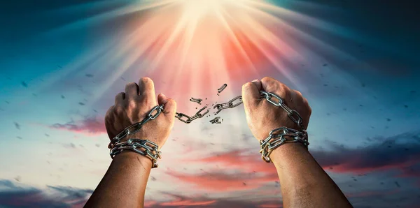 stock image Hands in fists breaking a chain freedom. The concept of gaining freedom.