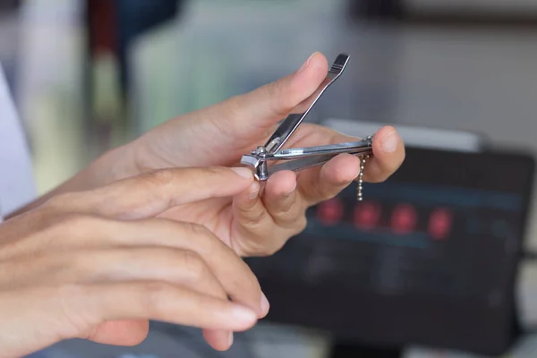 nail clipper and Hand cutting nails using , fringger - close up