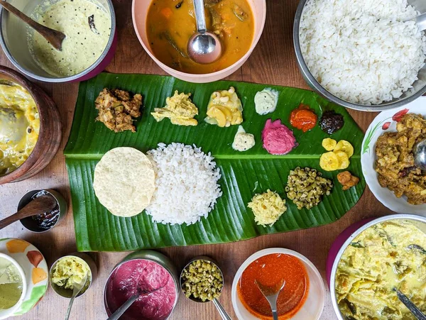 traditional south indian food platter with rice and other variety food items served in a banana leaf for a festival or occasion