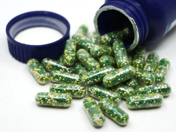 Tobolky Zelenými Žlutými Bílými Pilulkami Obsahujícími Vitamíny Doplňky Živin Rozprostřené — Stock fotografie