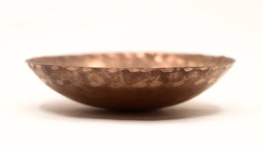 Mutfak için beyaz arka planda izole edilmiş boş bir bakır kaseye yakın plan.