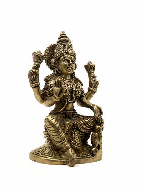 detailed bronze sculpture from ancient india of hindu goddess lakshmi with four hands sitting and blessing isolated