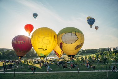 Vilnius, Litvanya - 08 05 2022: Vilnius 'ta sıcak hava balonları. Kalkıştan önce yerde çok renkli sıcak hava balonları var. Sahada bir sürü balon var.