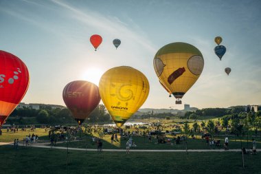 Vilnius, Litvanya - 08 05 2022: Vilnius 'ta sıcak hava balonları. Kalkıştan önce yerde çok renkli sıcak hava balonları var. Sahada bir sürü balon var.