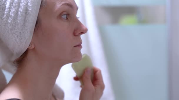 Woman Makes Facial Massage Gouache Scraper Looks Mirror She Wearing — Stock Video