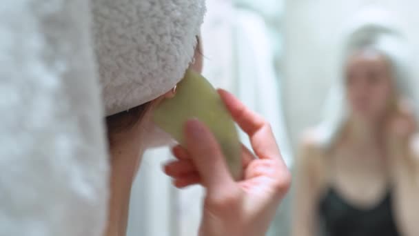 Woman Makes Facial Massage Gouache Scraper Looks Mirror She Wearing — Stock Video