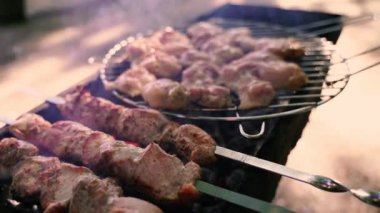 Şişte ızgara et, ızgarada kahverengi et. Doğadaki mangal üzerinde shashlik pişirmek. Shashlik kömürde pişiyor. 4k