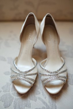 Beautiful designer silver wedding shoes with rhinestone embellished. Wedding details. Bridal shoes. Wedding concept 