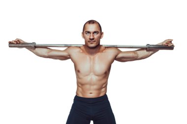 Muscular bodybuilder guy doing exercises with barbell over white background. Copy Space. Sport concept 