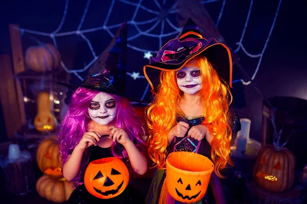 Two Little Girls Witches Carnival Costume Holding Pumpkins Candies Background — Stok fotoğraf