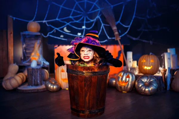 Little Girl Witches Carnival Costume Scaring Making Faces While Sitting Stock Photo