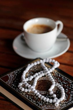 Islamic prayer beads, Quran and cup of coffee. 