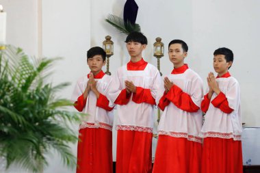 Palm sunday mass. Altar boys.  Hoi An Cathedral.  Vietnam. 