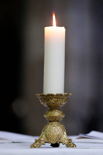 St Peter church.  Church candle on altar.  Dreux. France.