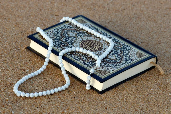 Islamic prayer beads and Quran.