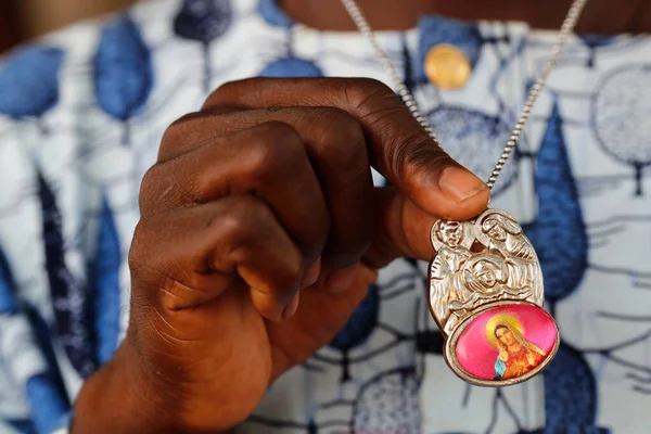 Catholic man with holy family medaillon. Close-up.  Datcha-Attikpaye. Togo.