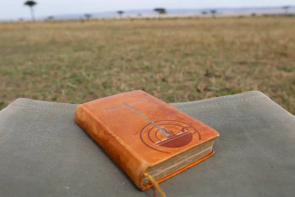 Bible on a  safari folding chair.  Masai Mara. Kenya.