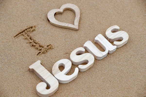 Drewniane Litery Tworzące Słowo Jezus Sercem Tle Piasku Plażowego Kocham — Zdjęcie stockowe