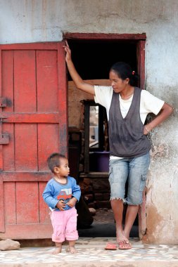 Mother and son in front of their house.  Madagascar. 