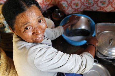 Malagasy woman working in kitchen.  Portrait.  Madagascar. 