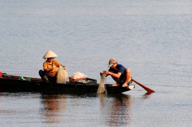 Vietnamese couple fishing in Huong River ( Perfume River).  Hue. Vietnam. 
