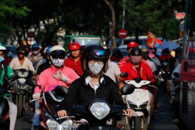 People riding motorbikes.  Road traffic.  Ho Chi Minh City. Vietnam.